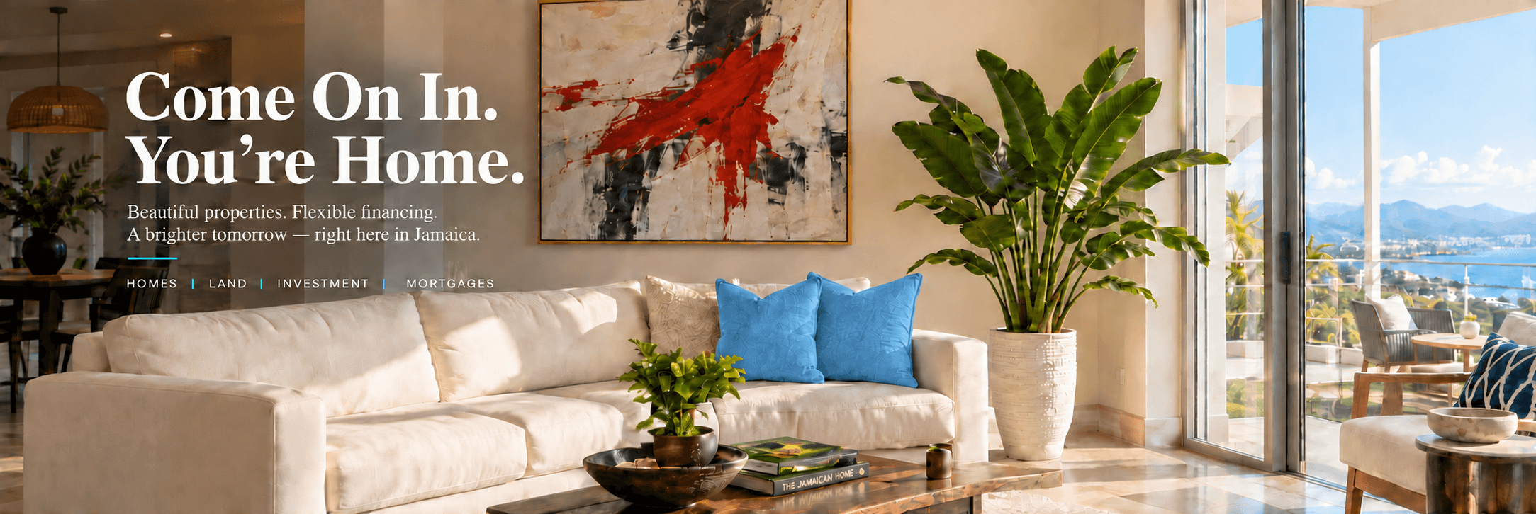 IDJ living room hero — cream sectional with blue pillows, red-accented painting, potted plant, ocean-view windows